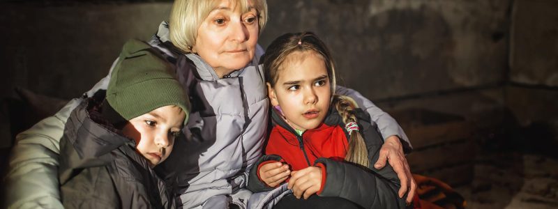 grandmother-hugs-little-ukrainian-kids-they